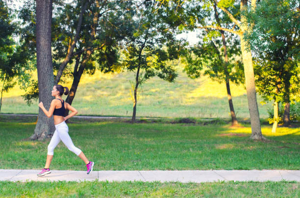 Sportswoman running in the nature on a beautiful summer day.