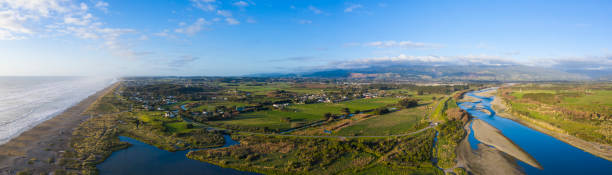 Aerial panorama of the Otaki area in New Zealand's Kapiti Coast area A stitched elevated drone shot taken from Otaki River mouth looking north over the township of Otaki with the Tararua mountain to the east tasman sea stock pictures, royalty-free photos & images