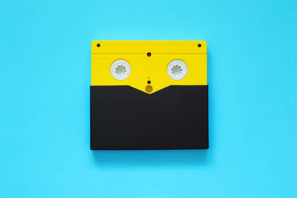 istock Yellow video tape on color background, VHS 1177736237