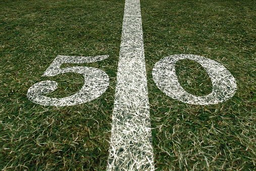 American Football field 50 yard score line. Team sports. Fifty yard line.