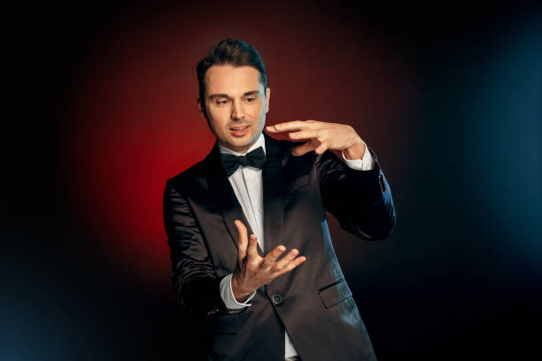 istock Professional Occupation. Showman in suit standing isolated on wall showing trick impressed 1177751830