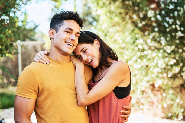 istock Couple with arm around standing in backyard 1177751945