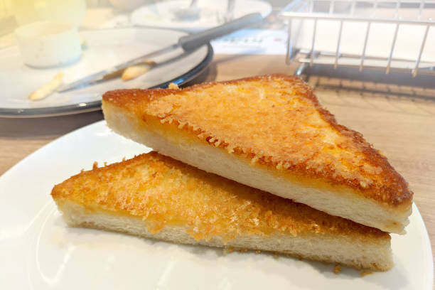 Garlic bread cut into triangles on a white plate