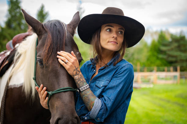 istock Female rancher working with her horse 1177760563