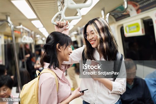 istock Two Asian girls traveling to school by metro 1177762869