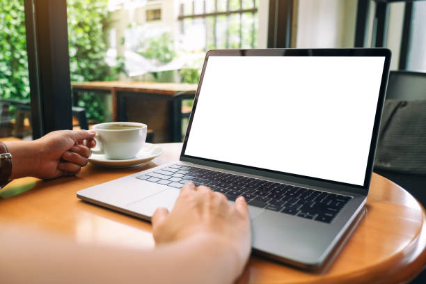 istock a woman using and touching laptop touchpad with blank white desktop screen while drinking coffee 1177767363