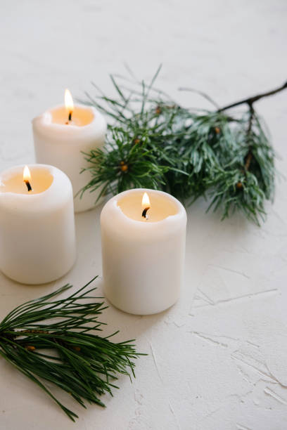 istock White Candles. Christmas mood. Flaming candles on table. 1177771971