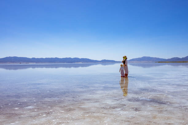 istock mother and daughter by the lake side 1177773244