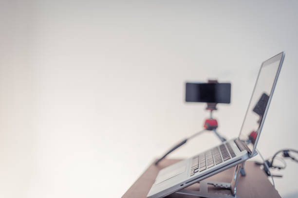 A laptop with a mobile on the table