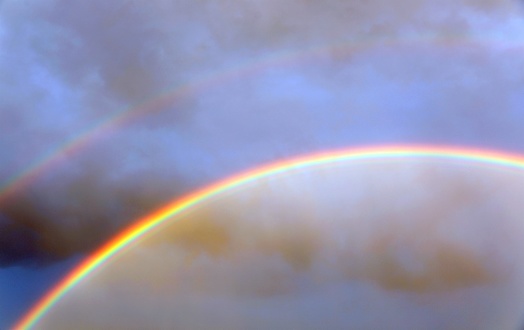 double rainbow after the storm with vivid colors and blue sky