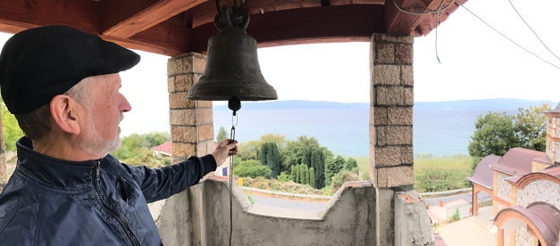 Couple in a Macedonian chapel, ringing the bell