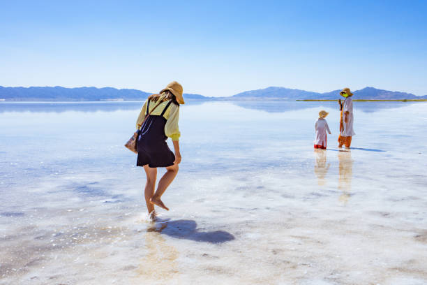 istock mother and two daughters by the lake side 1177794715