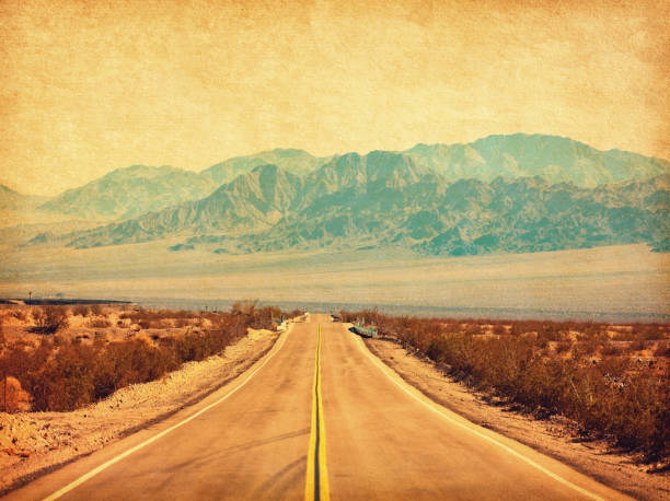 Route 66 crossing the Mojave Desert, California, United States.  Photo in retro style. Added paper texture. Toned image Route 66 crossing the Mojave Desert, California, United States.  Photo in retro style. Added paper texture. Toned image number 66 stock pictures, royalty-free photos & images