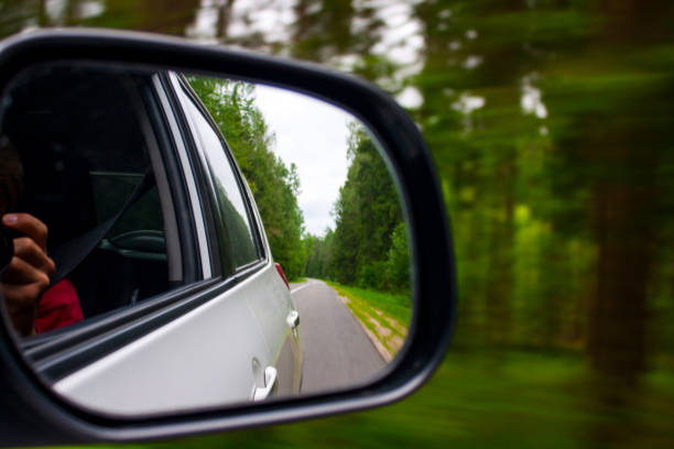 istock Forest highway in the side mirror green auto road 1177801069