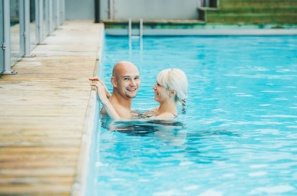 istock Couple is resting and relaxing in an indoor pool. Concept relaxation 1177801294