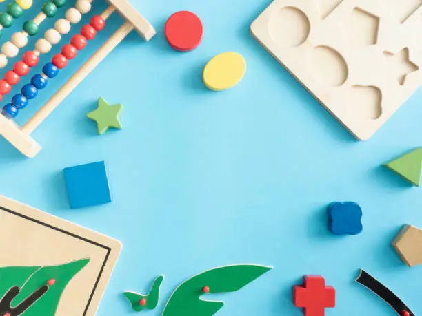 Photo of kids learning concept with stacking toys on blue table background.