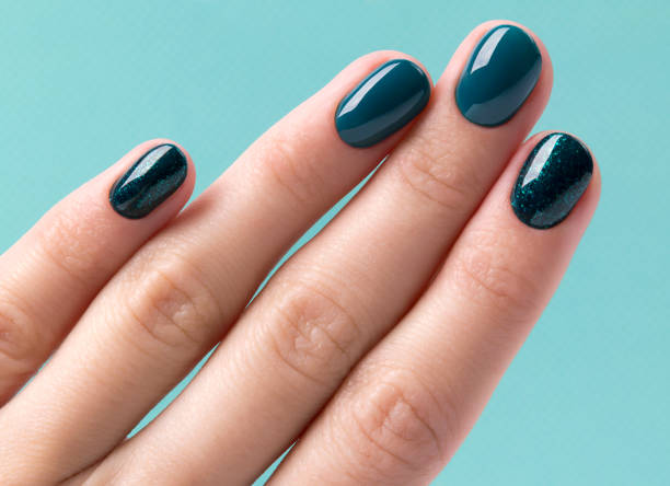 istock Manicured woman's hand on turquoise pastel background 1177802747