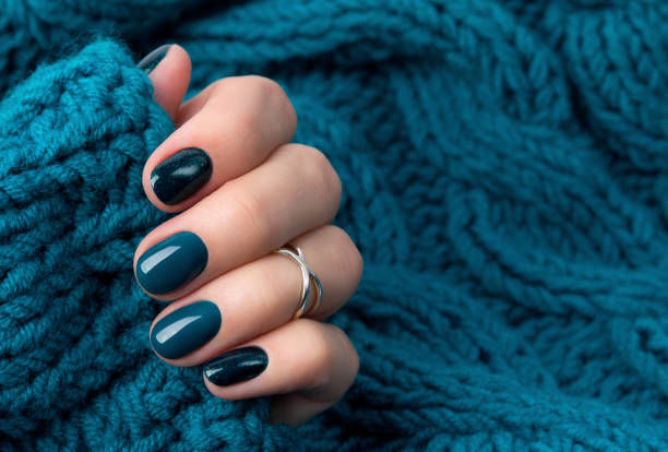 istock Manicured woman's hand in warm wool turquoise sweater 1177802761