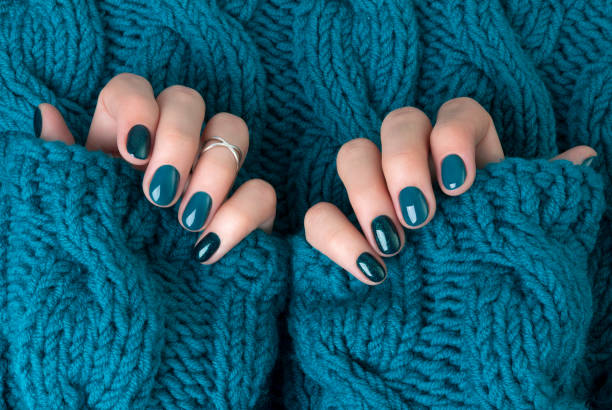 istock Manicured woman's hands in warm wool turquoise sweater 1177802796