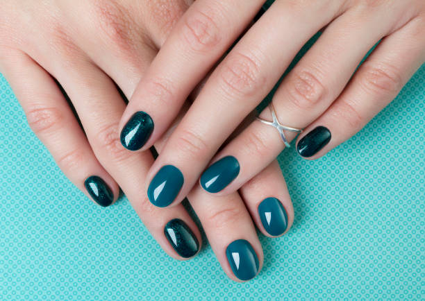 istock Woman's hands with turquoise manicure on creative background 1177802844