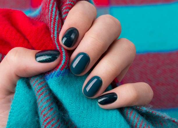 istock Manicured woman's hands holding warm wool turquoise fabric 1177802855
