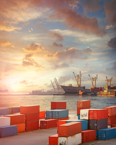 Cargo ship and containers in the port Freight ship, cranes and cargo containers in the harbor in sunset light cargo container shipping harbor trading stock pictures, royalty-free photos & images