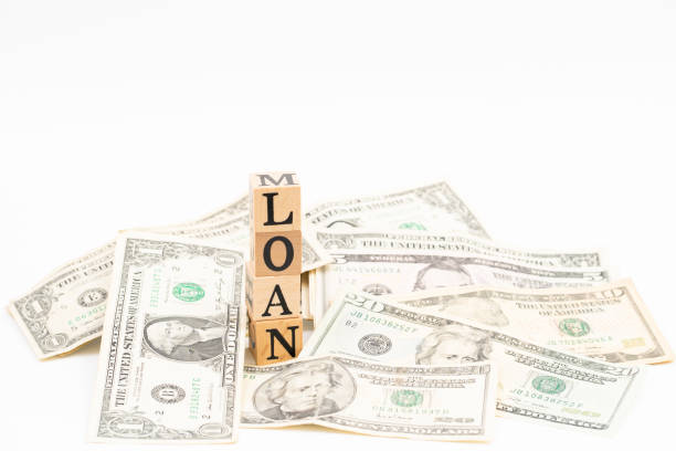 istock Wood block loan word with dollar banknote on white background. 1177808805