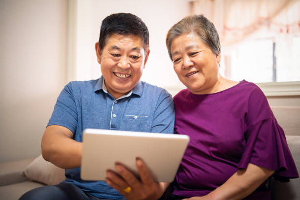 istock Senior Asian couple using a digital tablet at home 1177810593
