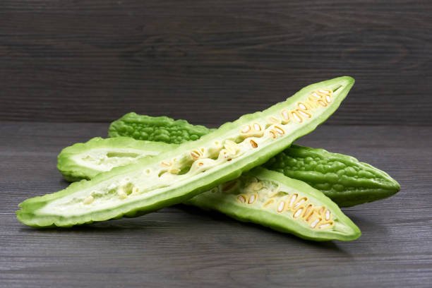 istock Bitter melon , Bitter gourd isolated on wood background. 1177810727