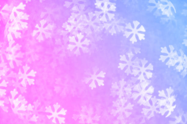 Multi colored Christmas background - defocused bokeh with snowflakes shape. Space for copy. It's a real bokeh photo, not an illustration or computer filter.