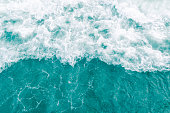 Turquoise olive green gentle breeze ocean wave during summer tide