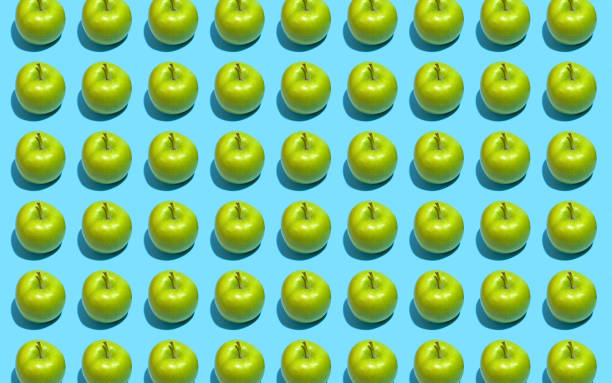 istock Fruit pattern of fresh green apples on blue background. Top view. Summer concept. Collage 1177813269