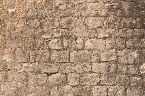 Background texture of the old fortress stone wall. Conceptual background for designers