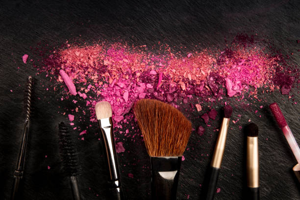 istock Make-up brushes with crushed cosmetics, shot from the top on a black background with copy space, a beauty design template for a makeup banner 1177814479