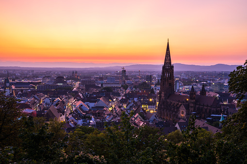 Germany, Magical sunset red sky over city freiburg im breisgau and famous minster church aerial view in summer
