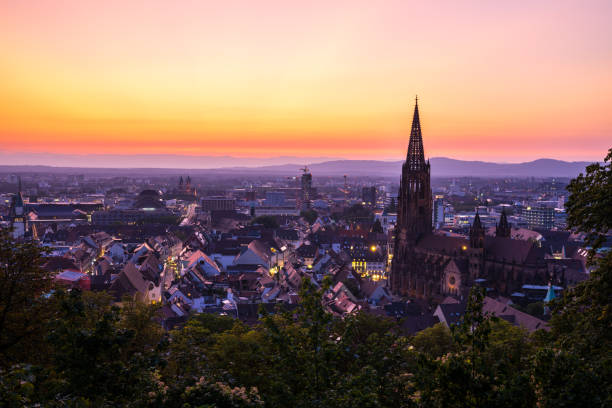 Germany, Magical sunset red sky over city freiburg im breisgau and famous minster church aerial view in summer stock photo