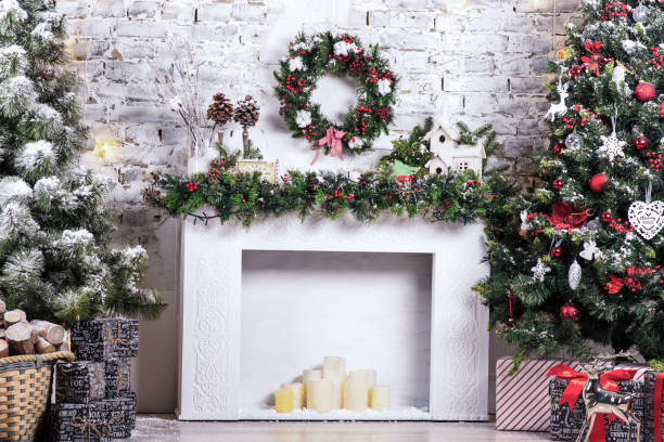 istock New Year decorated. Interior bright room with Christmas decoration. Fir-tree, gift boxes, fireplace decorated with garlands holiday. Celebration photo 1177816730