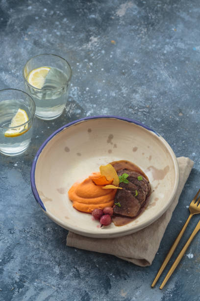 Braised lamb with sweet potato puree, restaurant dish, copy space