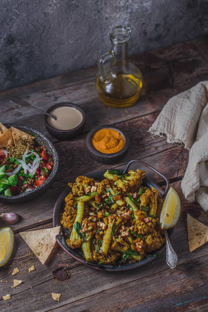 istock Deep Fried Cauliflower with eggplant salad and crusty bread, copy space 1177816920