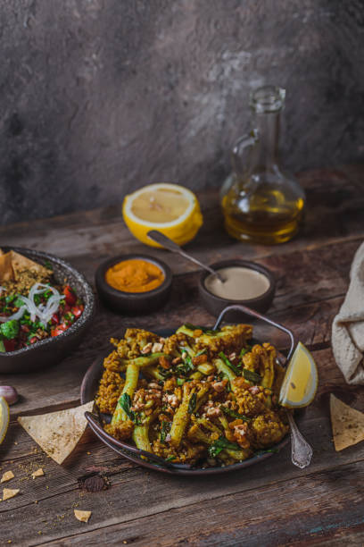 istock Deep Fried Cauliflower with eggplant salad and crusty bread, copy space 1177816953