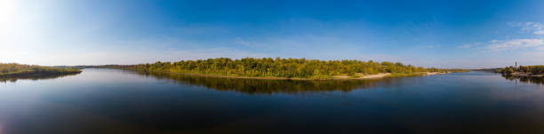 istock Panorama over the water surface to the autumn forest 1177818053