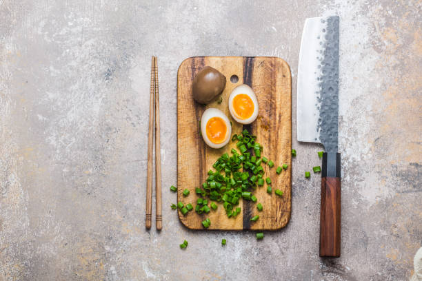 Japanese marinated eggs for ramen on cutting board, copy space stock photo