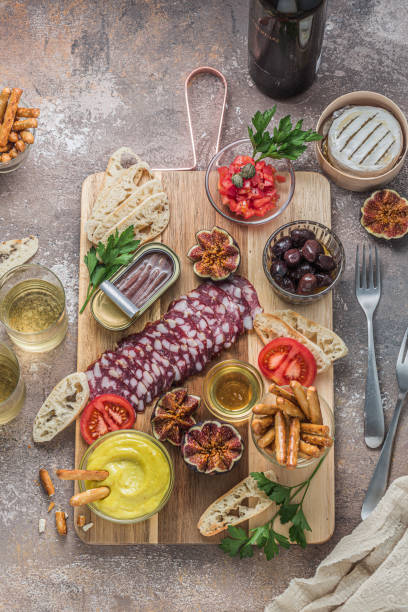 istock Wine apetizer set with salami, cheesem tomato, bread and alioli dip 1177820068