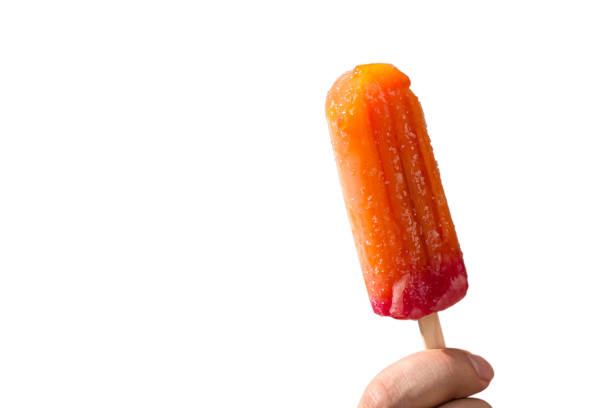 istock Juicy popsicles on a stick in a hand on a white background 1177825921