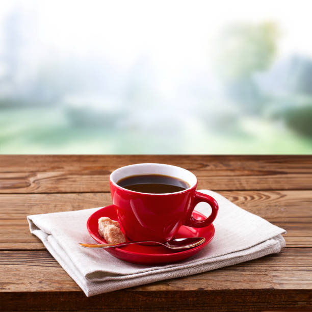 red cup of tasty coffee on napkin, on wooden table. autumn background - coffee cup isolated cappuccino multi colored imagens e fotografias de stock