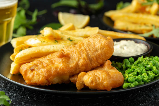 istock British Traditional Fish and chips with mashed peas, tartar sauce and cold beer. 1177829065