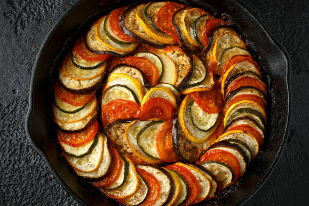 istock Ratatouille Vegetable Stew with zucchini, eggplants, tomatoes, garlic, onion and basil. on cast iron pan. Traditional French food. 1177829285