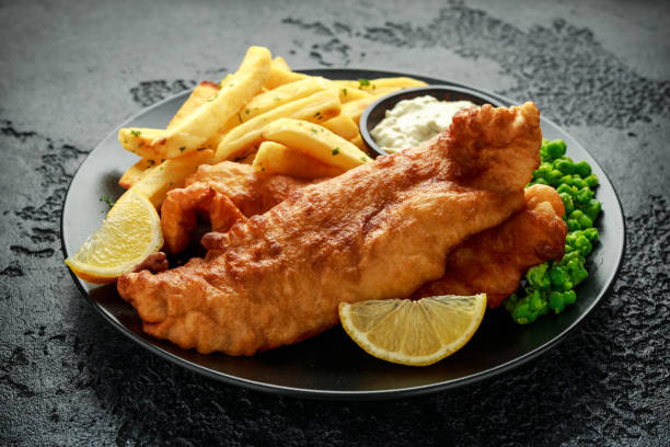 istock British Traditional Fish and chips with mashed peas, tartar sauce and cold beer. 1177829489