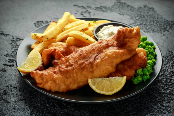 british traditional fish and chips with mashed peas, tartar sauce and cold beer. - main course imagens e fotografias de stock