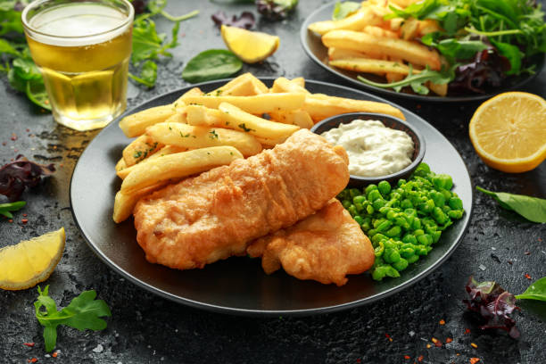 istock British Traditional Fish and chips with mashed peas, tartar sauce and cold beer. 1177829523